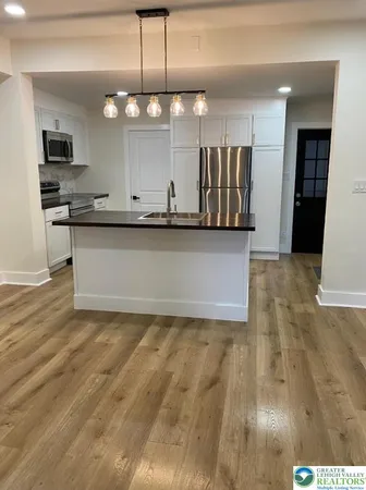 a view of kitchen with wooden floor