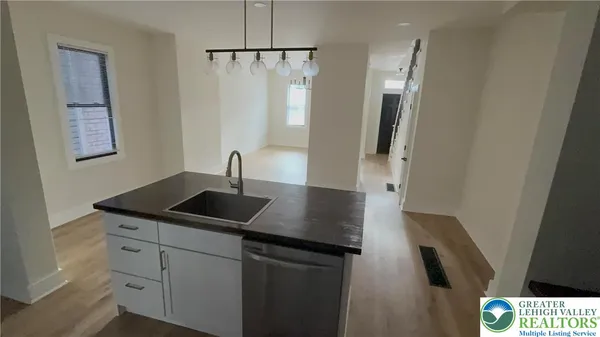 a kitchen with a sink and refrigerator