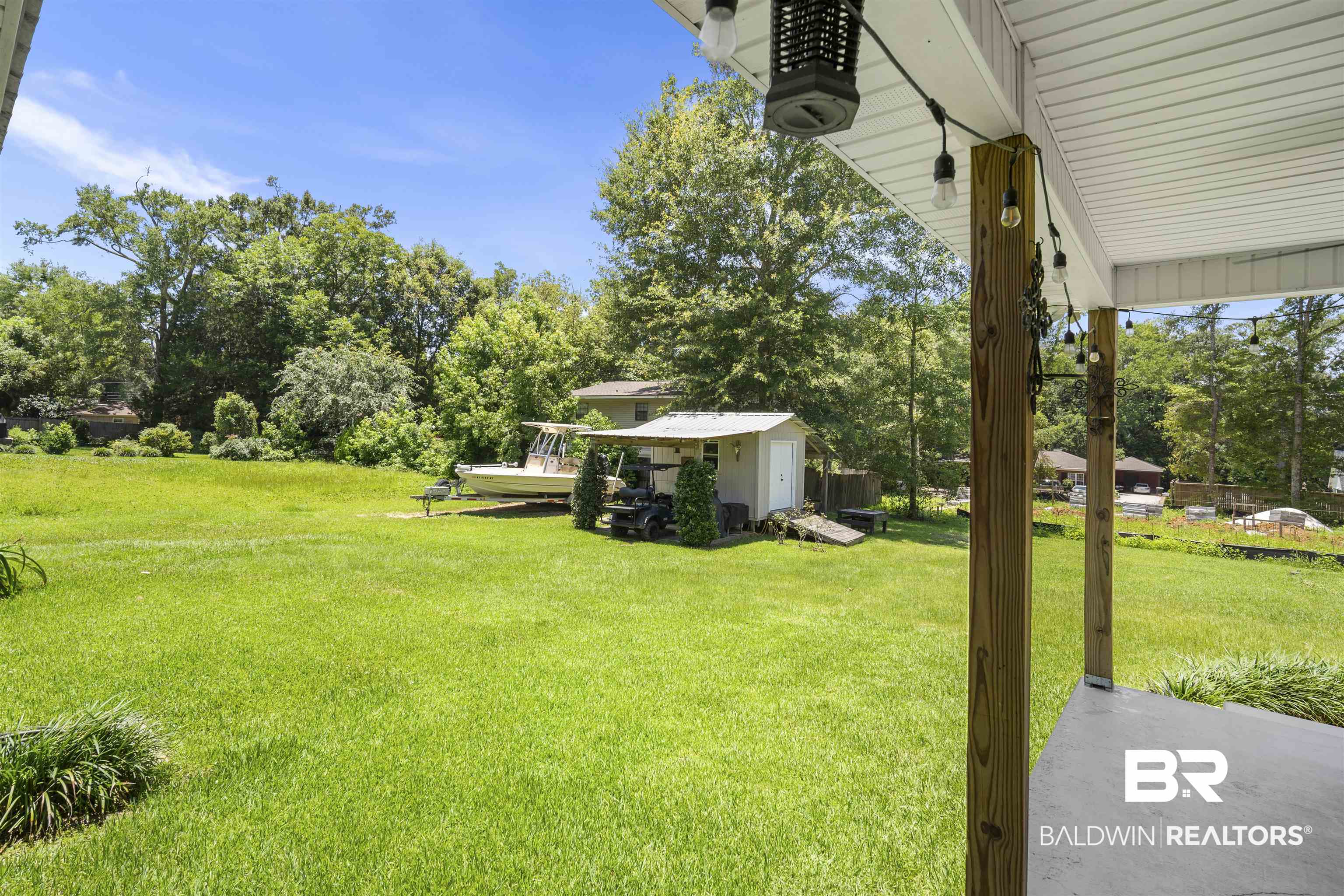 1615 5th Street Daphne, AL 36526 - Photo 26 of 28 Expansive green lawn with established trees and a storage shed