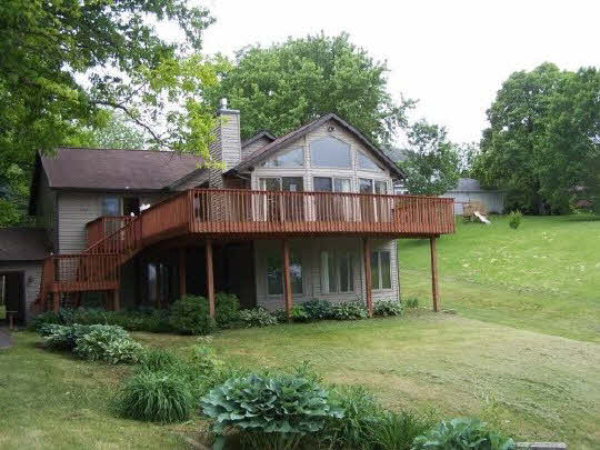 1967 Baintree Road Lake Summerset, IL 61019 - Photo 1 of 1 a front view of a house with a garden and plants