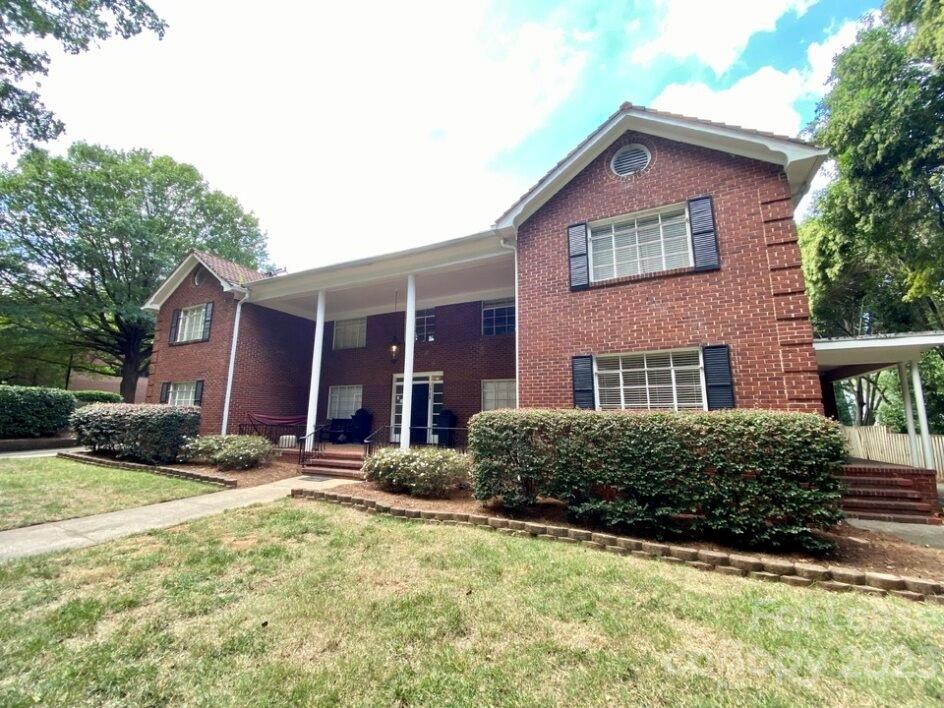 1708 Dilworth Road West, Unit 9 Charlotte, NC 28203 - Photo 1 of 14 a front view of a house with yard and parking