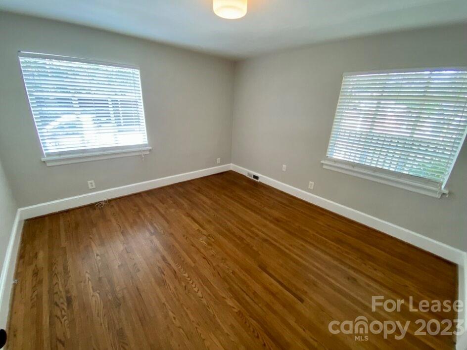 1708 Dilworth Road West, Unit 9 Charlotte, NC 28203 - Photo 13 of 14 a view of an empty room with wooden floor and a window