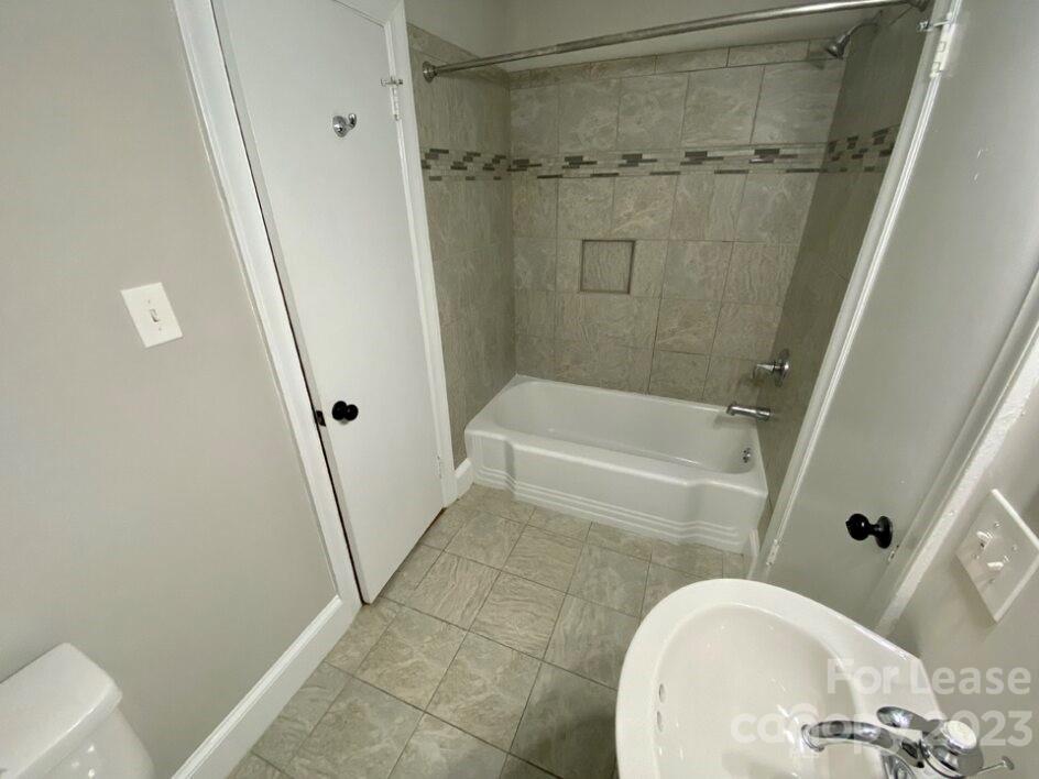 1708 Dilworth Road West, Unit 9 Charlotte, NC 28203 - Photo 14 of 14 a bathroom with a sink and a mirror
