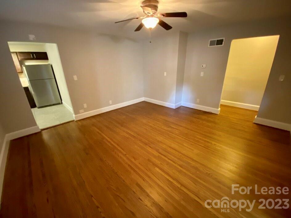 1708 Dilworth Road West, Unit 9 Charlotte, NC 28203 - Photo 3 of 14 a view of an empty room with wooden floor and a window