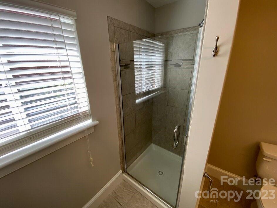 1708 Dilworth Road West, Unit 9 Charlotte, NC 28203 - Photo 10 of 14 a bathroom with a window and a shower