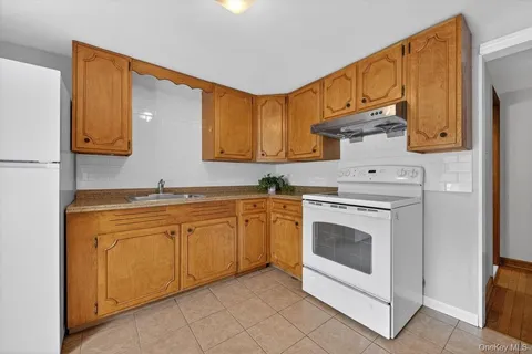 a kitchen with stainless steel appliances granite countertop a sink and cabinets