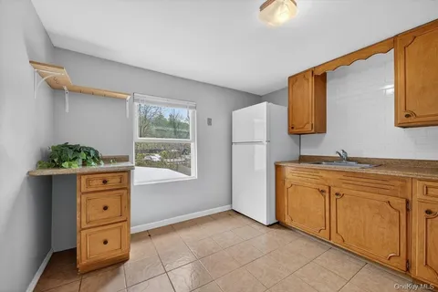 a kitchen with granite countertop a stove a sink and a window