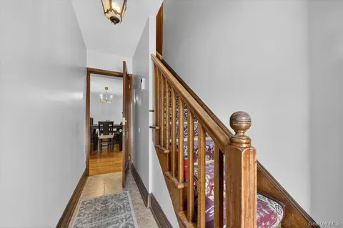 a view of a hallway with wooden floor and stairs