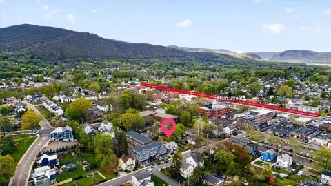 a view of a lush green hillside and houses