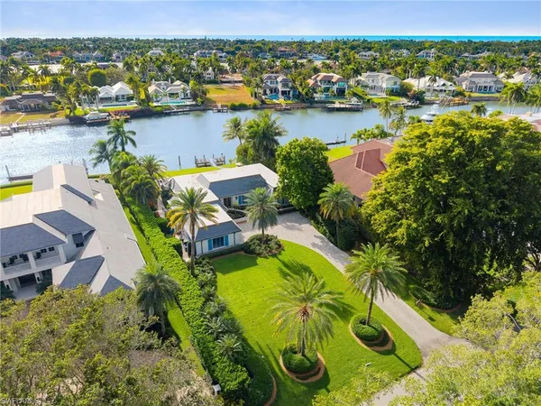 an aerial view of lake residential houses with outdoor space and swimming pool