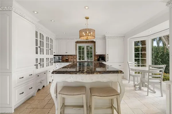a dining room with furniture and a floor to ceiling window