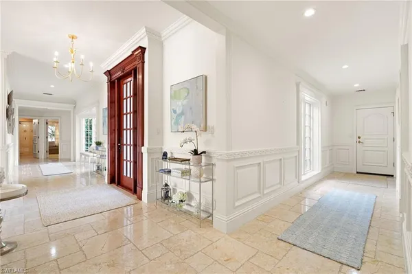 a view of a dining room with furniture a rug and wooden floor