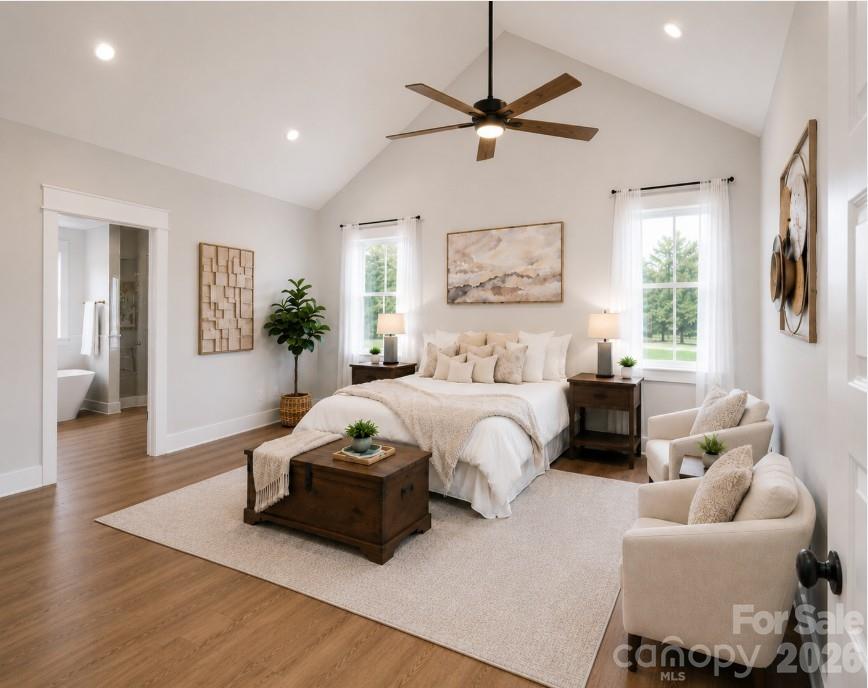 9745 Flowes Store Road Midland, NC 28107 - Photo 12 of 20 a spacious bedroom with a bed and a chandelier