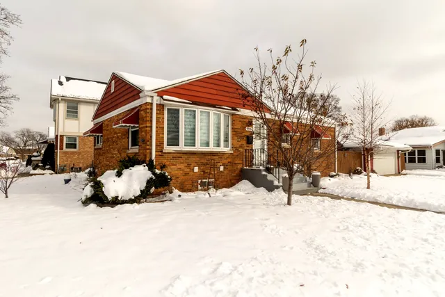 a view of a house with snow on the road