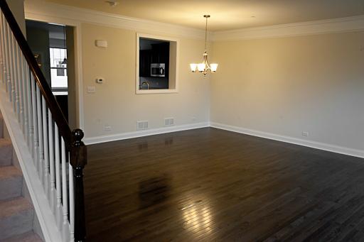 309 South NW Highway, Unit 2 Park Ridge, IL 60068 - Photo 7 of 11 an empty room with wooden floor and windows