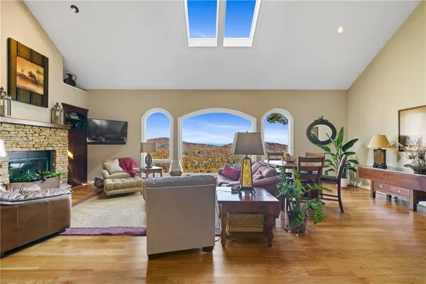 a living room with fireplace furniture and a large window