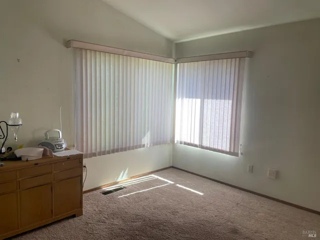 a room with a window and a dresser