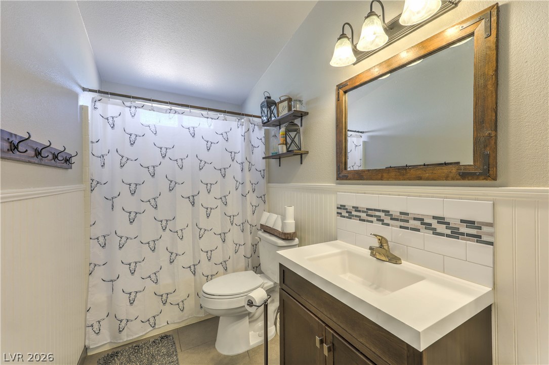 348 Tres Palomas Street Overton, NV 89040 - Photo 27 of 41 A compact bath features a rustic mirror above the vanity, enhancing the home's character.