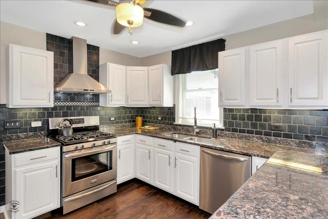 18424 Riegel Road Homewood, IL 60430 - Photo 3 of 25 a kitchen with stainless steel appliances granite countertop a stove sink and cabinets