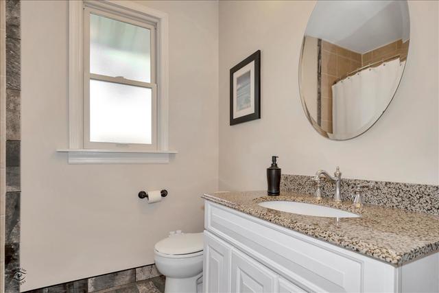 18424 Riegel Road Homewood, IL 60430 - Photo 10 of 25 a bathroom with a granite countertop toilet sink and mirror