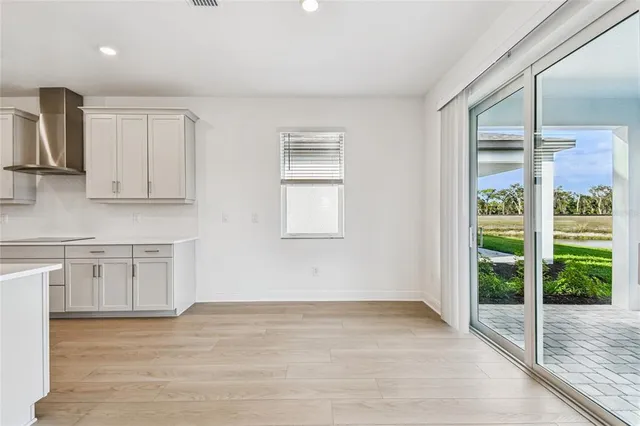 a view of kitchen with wooden floor and electronic appliances
