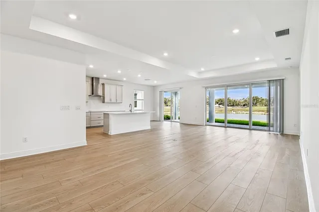 an empty room with an entryway and window