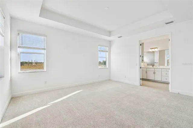a spacious bathroom with a double vanity sink a large mirror and shower