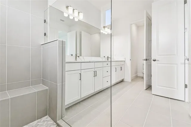 a bathroom with a sink vanity and mirror