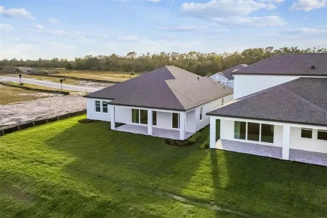 an aerial view of residential houses with outdoor space and swimming pool