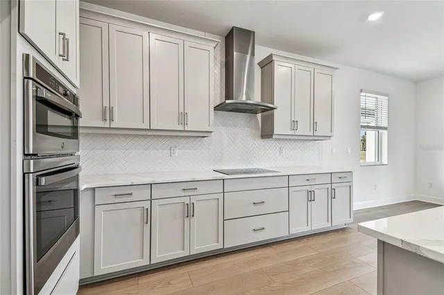 a kitchen with white cabinets stainless steel appliances and sink