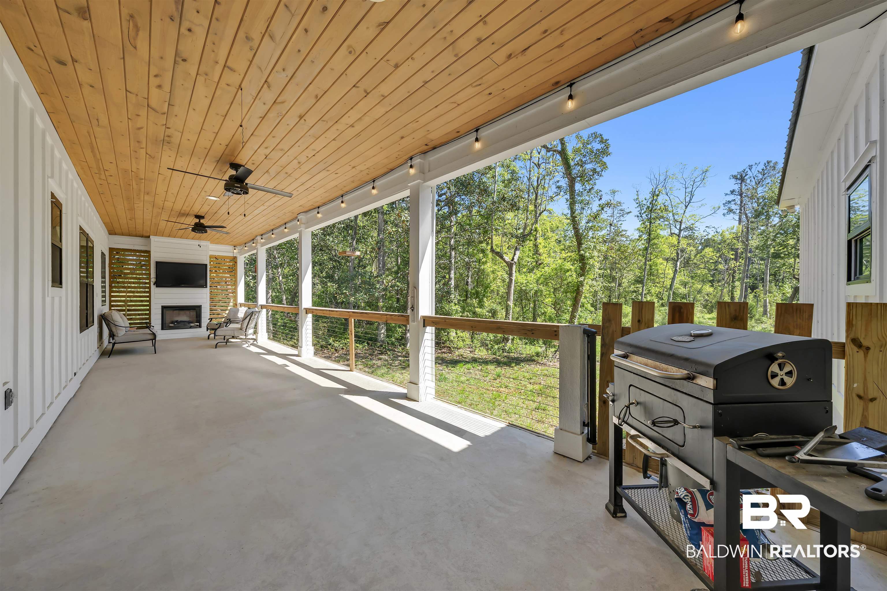 19058 James Road Gulf Shores, AL 36542 - Photo 38 of 49 Sunroom / solarium featuring track lighting, a ceiling fan, a patio, and a fireplace
