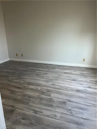 a view of an empty room and wooden floor
