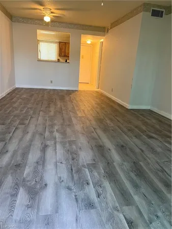a view of an empty room and wooden floor