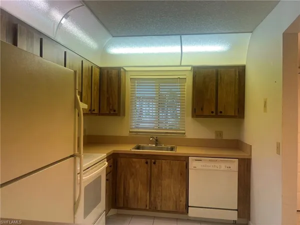 a kitchen with stainless steel appliances granite countertop a sink and cabinets