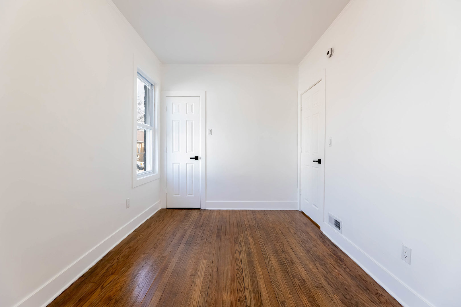6742 South Carpenter Street Chicago, IL 60621 - Photo 11 of 36 a view of a room with wooden floor and white walls