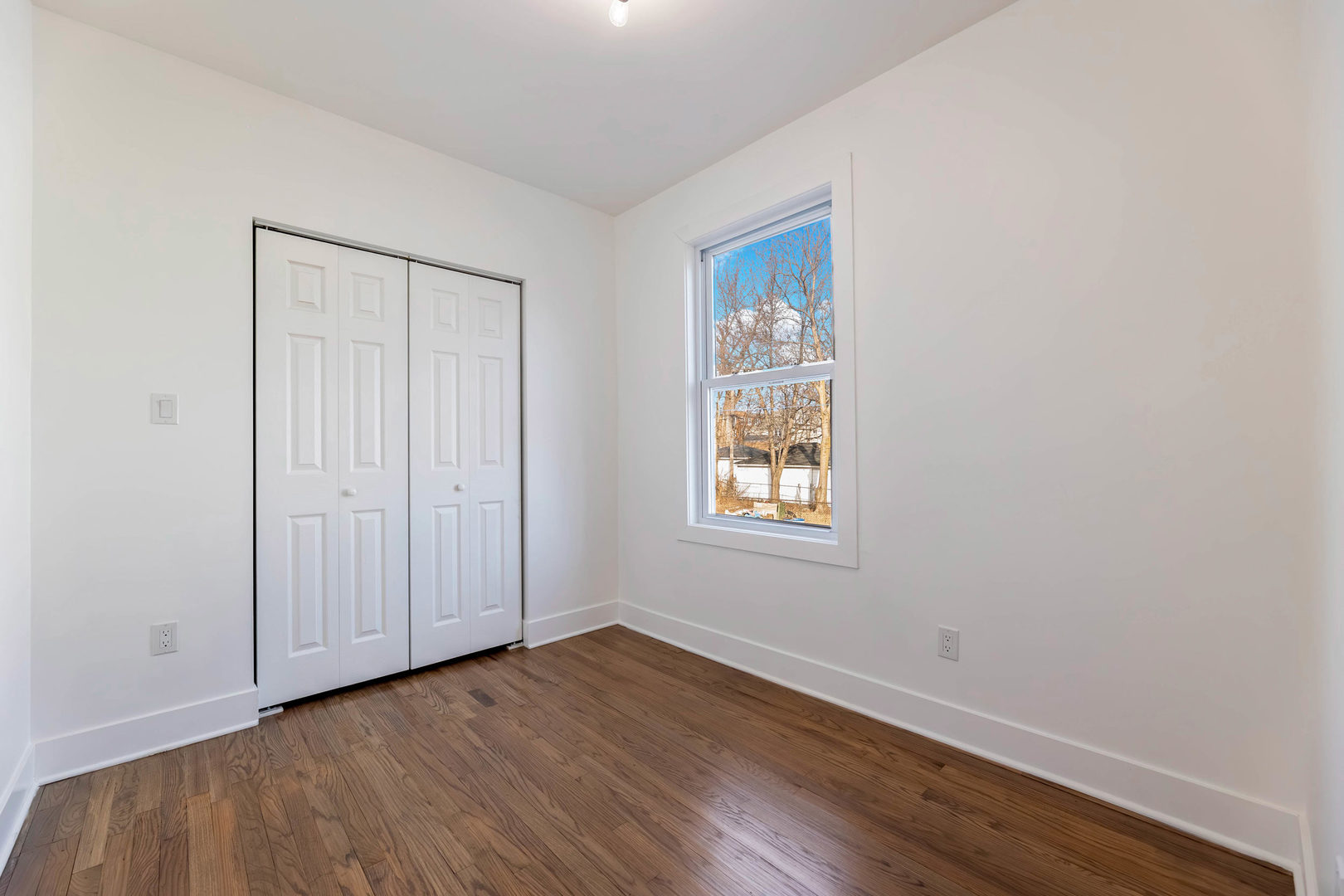 6742 South Carpenter Street Chicago, IL 60621 - Photo 14 of 36 an empty room with wooden floor and windows