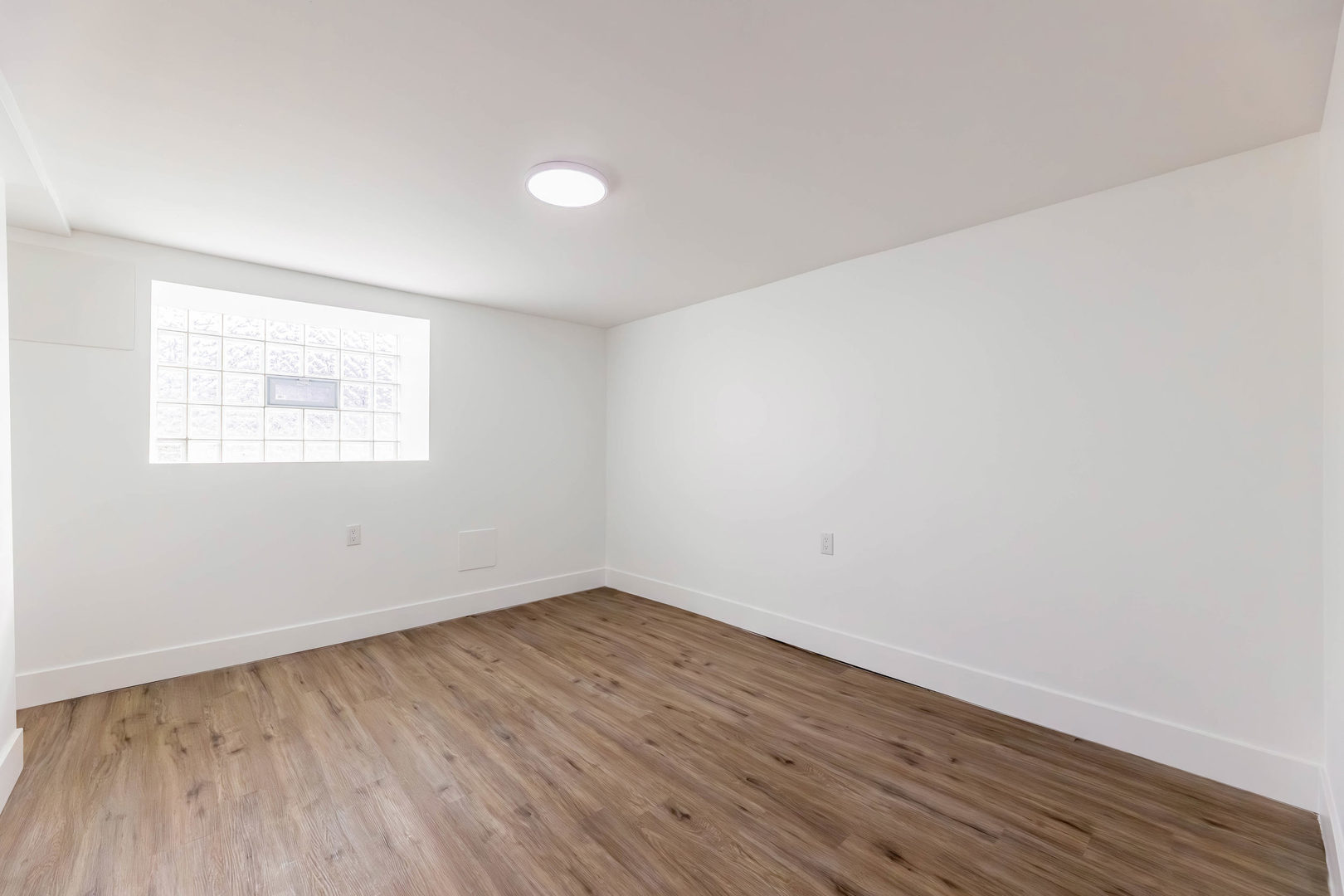 6742 South Carpenter Street Chicago, IL 60621 - Photo 24 of 36 an empty room with wooden floor and windows