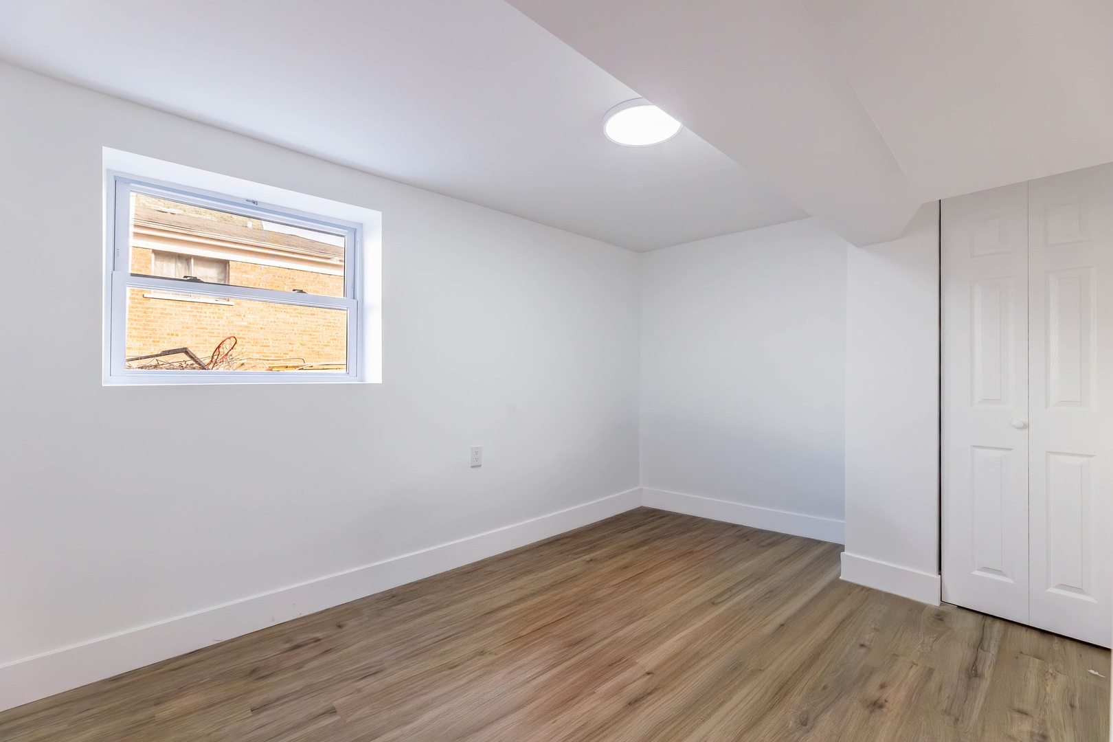 6742 South Carpenter Street Chicago, IL 60621 - Photo 25 of 36 a view of an empty room with wooden floor and a window