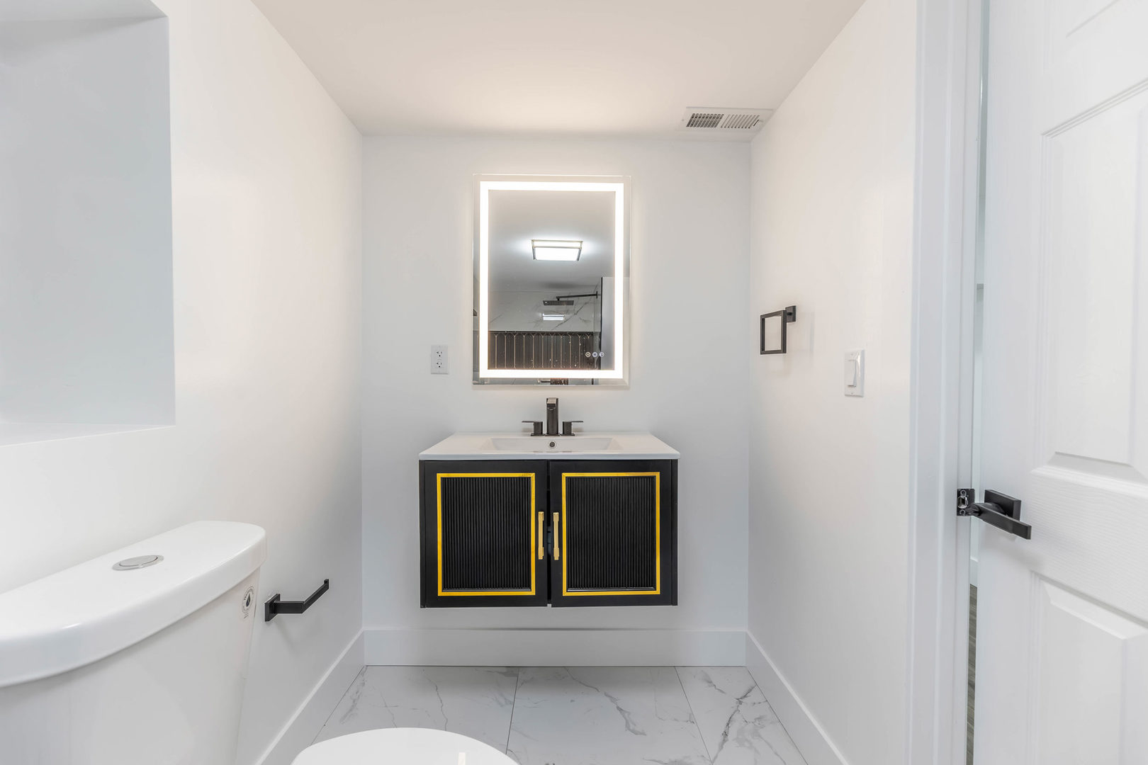 6742 South Carpenter Street Chicago, IL 60621 - Photo 27 of 36 a bathroom with a toilet sink and mirror