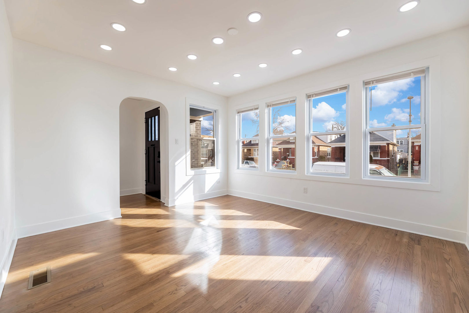 6742 South Carpenter Street Chicago, IL 60621 - Photo 3 of 36 a view of an empty room with window and wooden floor