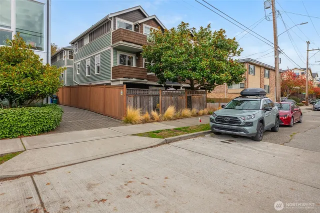 a view of a house with a car park side of a road