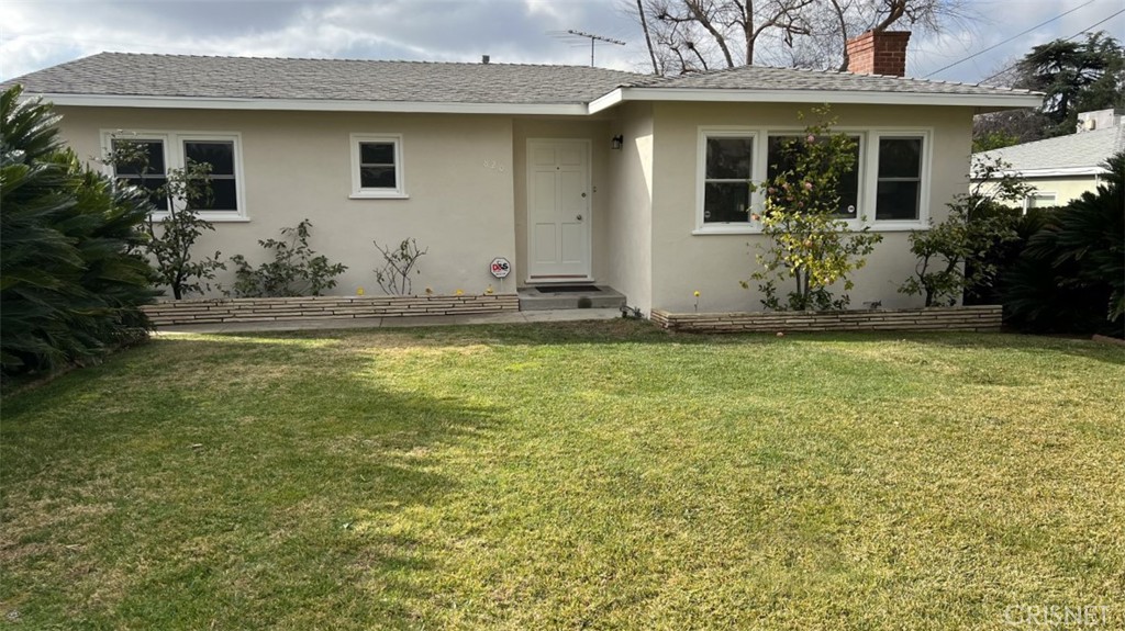 a view of a house with a yard and plants