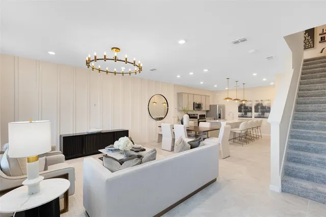 a living room with furniture a table and chairs