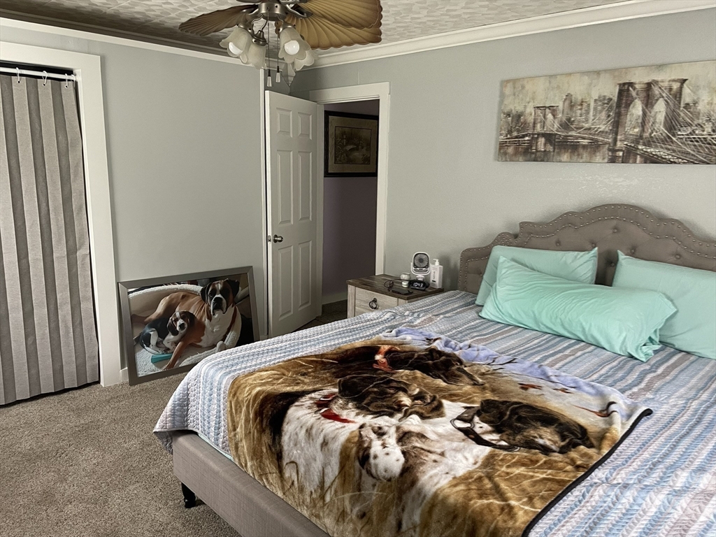 190 Turners Falls Road Montague, MA 01351 - Photo 16 of 35 a bedroom with a bed and a chandelier