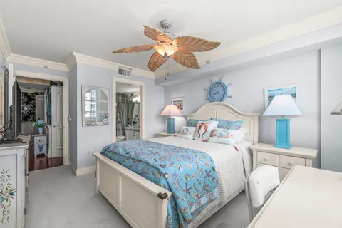 a bedroom with bed and a chandelier