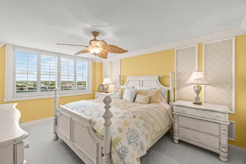 a spacious bedroom with a bed and a large window