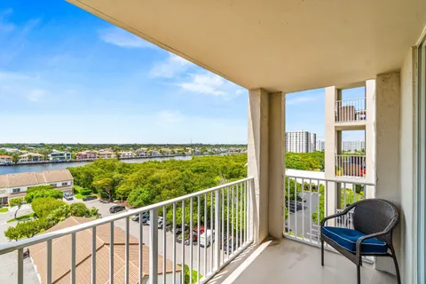 a view of a chairs and table in a balcony