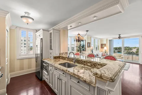 a kitchen with counter top space and wooden floor