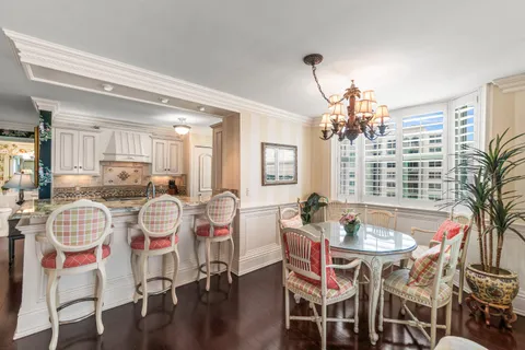 a dining room with furniture and wooden floor