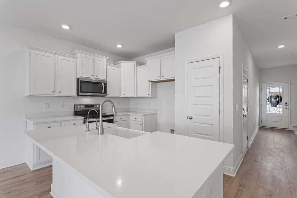 37 Phoenix Street Santa Rosa Beach, FL 32459 - Photo 8 of 26 a kitchen with kitchen island a sink stainless steel appliances and cabinets